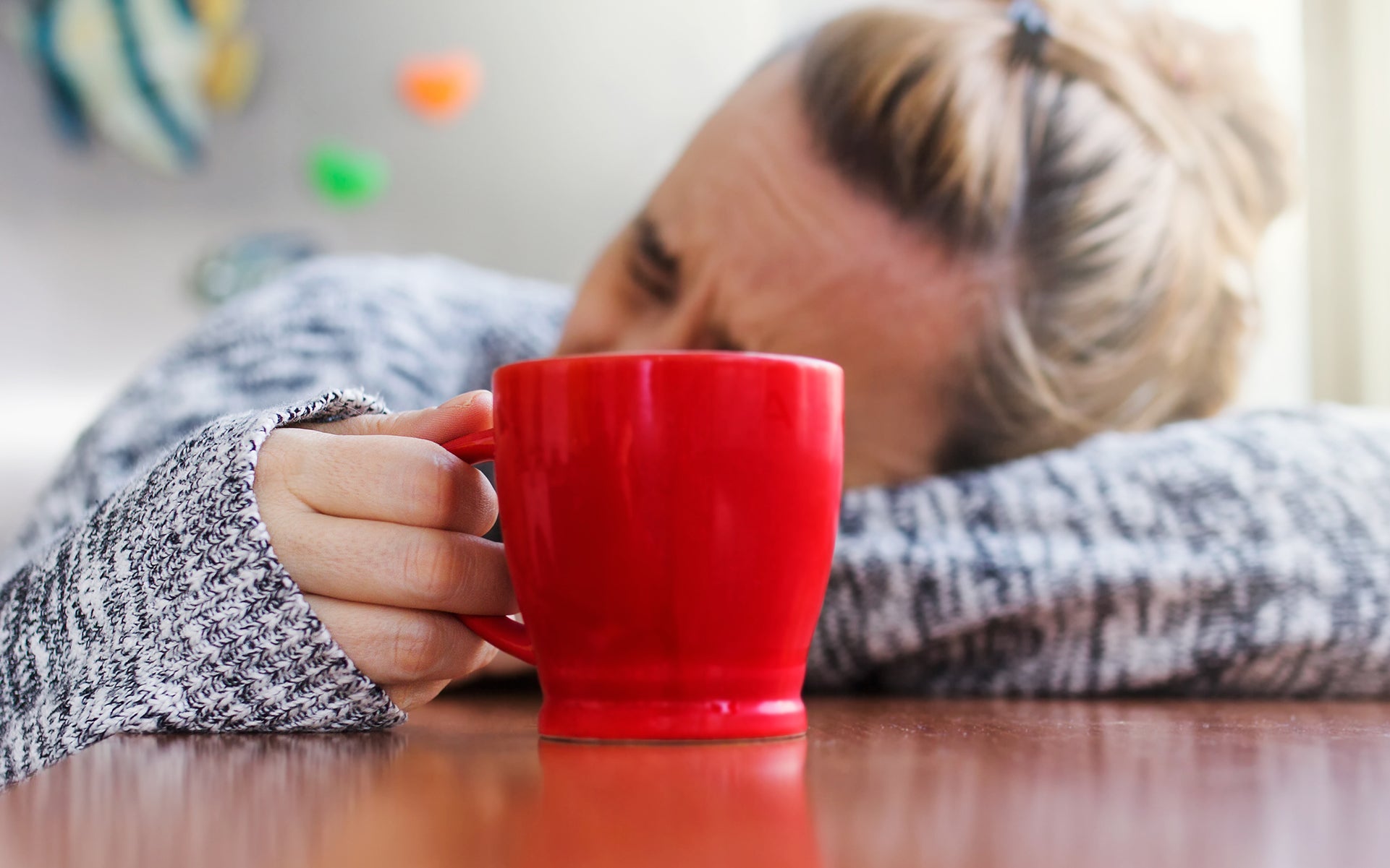Person holding a warm mug, suggesting comfort and rest